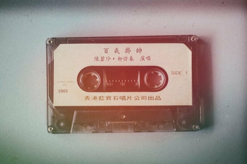 Cassette tape, representing the process of recording and distributing music in the rock era