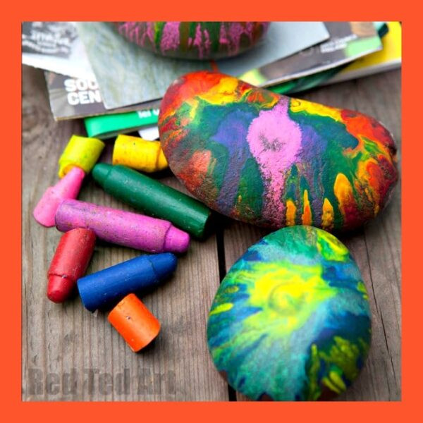 Easy Crayon Rock Paper Weights featuring colorful melted crayon designs displayed on a work surface.