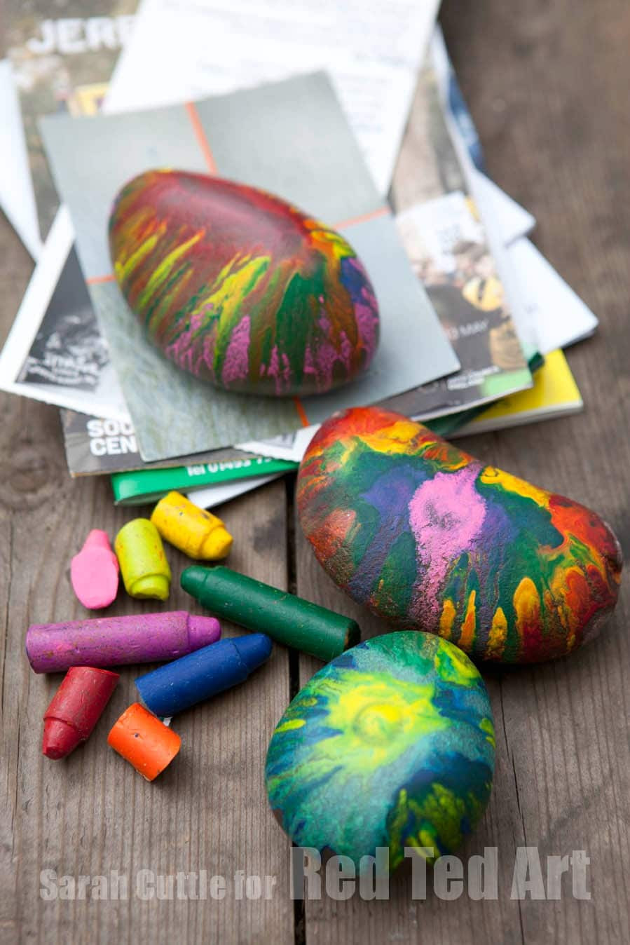 Collection of easy crayon rock paper weights featuring colorful melted crayon designs.
