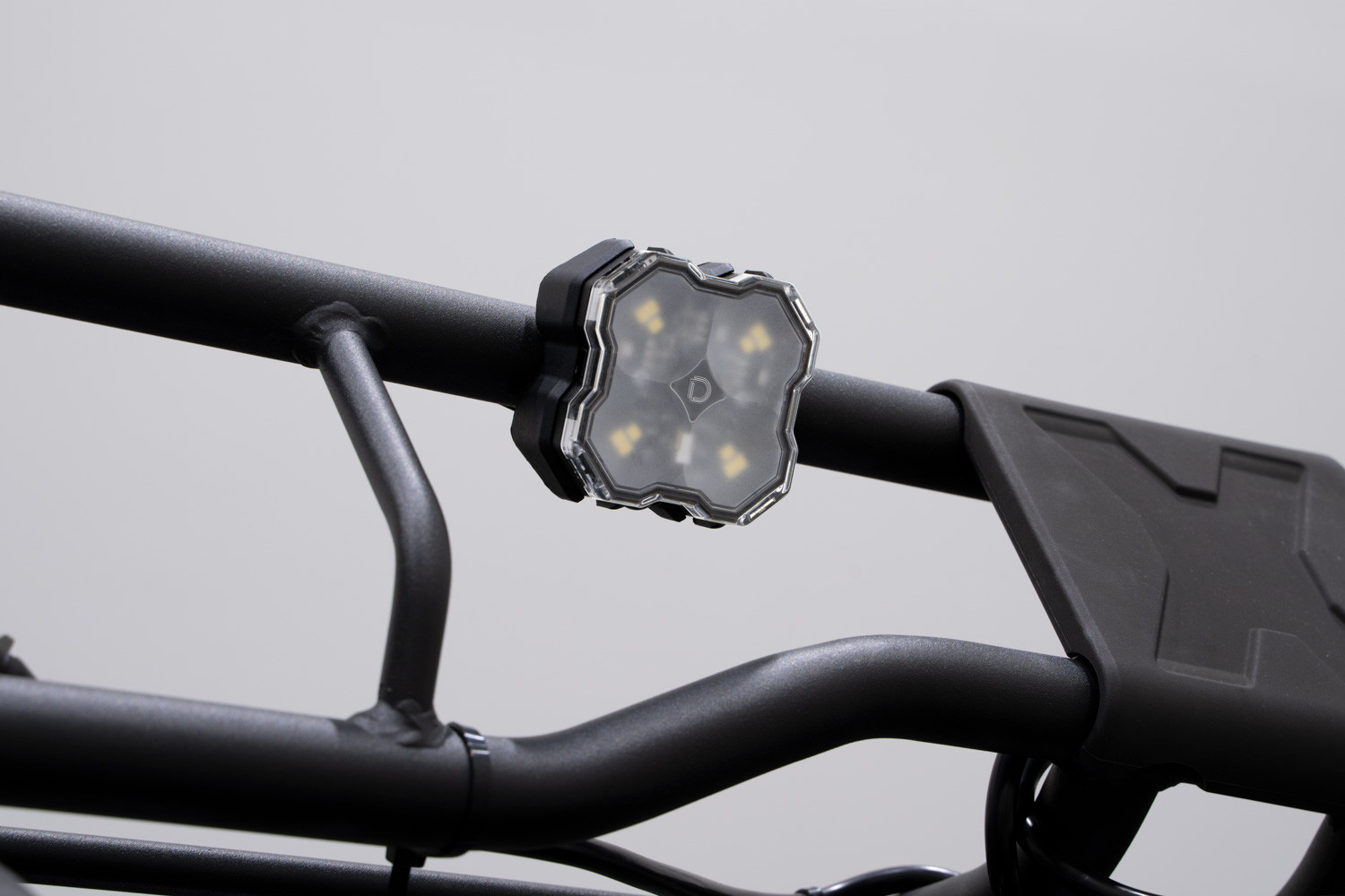 Rock light mounted on a roof rack using tube mounts