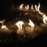 Fire glass pebbles in a blue fire pit