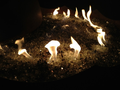 Fire glass pebbles in a blue fire pit