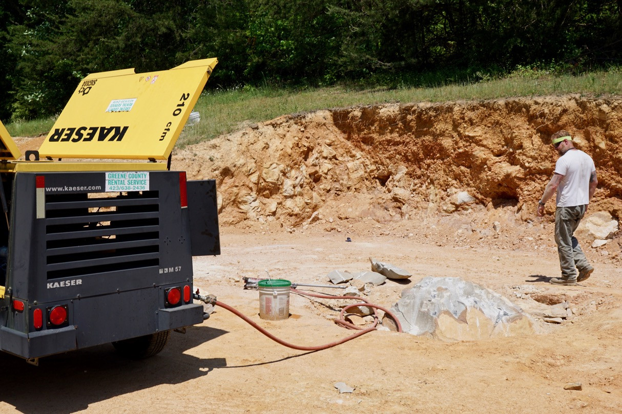 Air rock drill making holes for Dexpan