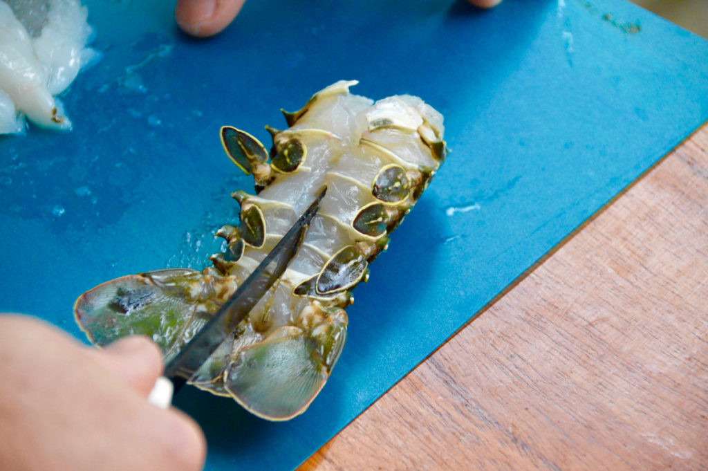 Rock lobster prepared for cooking, showcasing the butterflied tail and cleaned meat