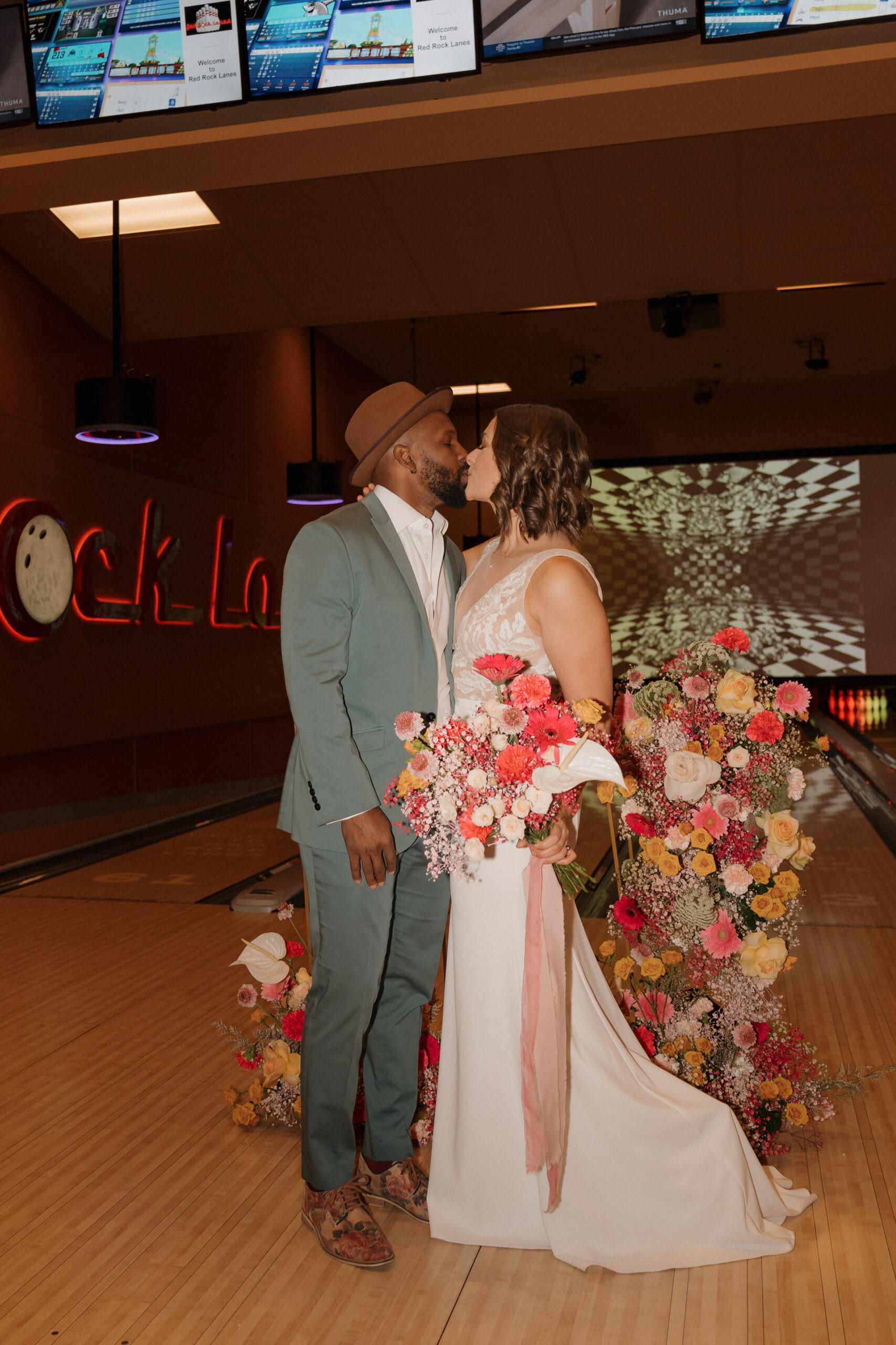 A vibrant cake adds a colorful touch to an elopement at Red Rock Lanes bowling alley
