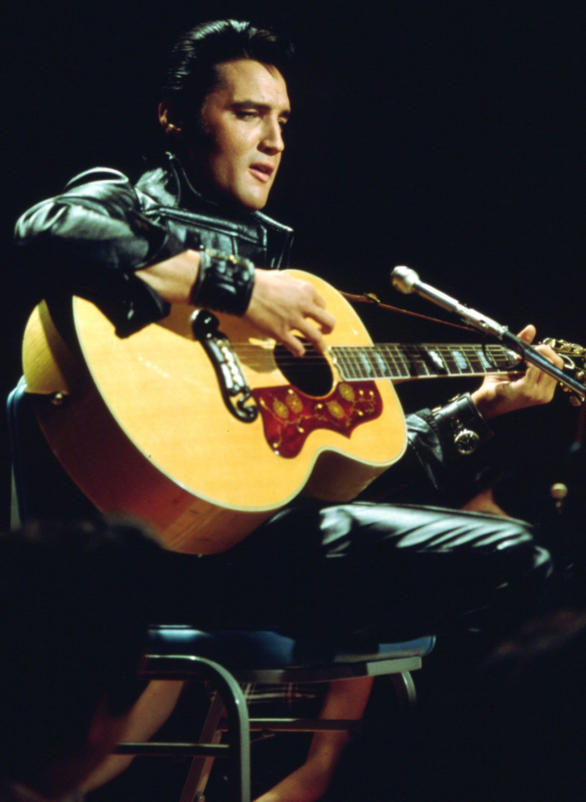 Elvis Presley, the King of Rock and Roll, performing with his guitar
