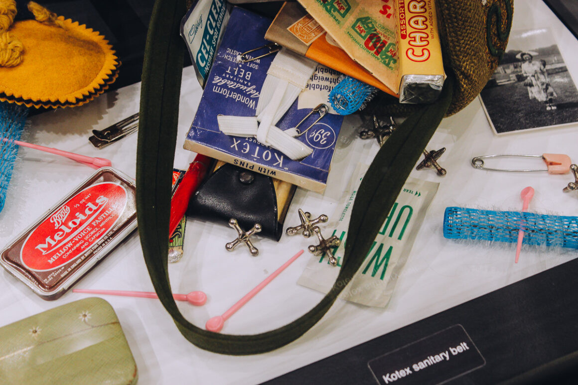 Purse display with typical contents, illustrating the personal items women carried