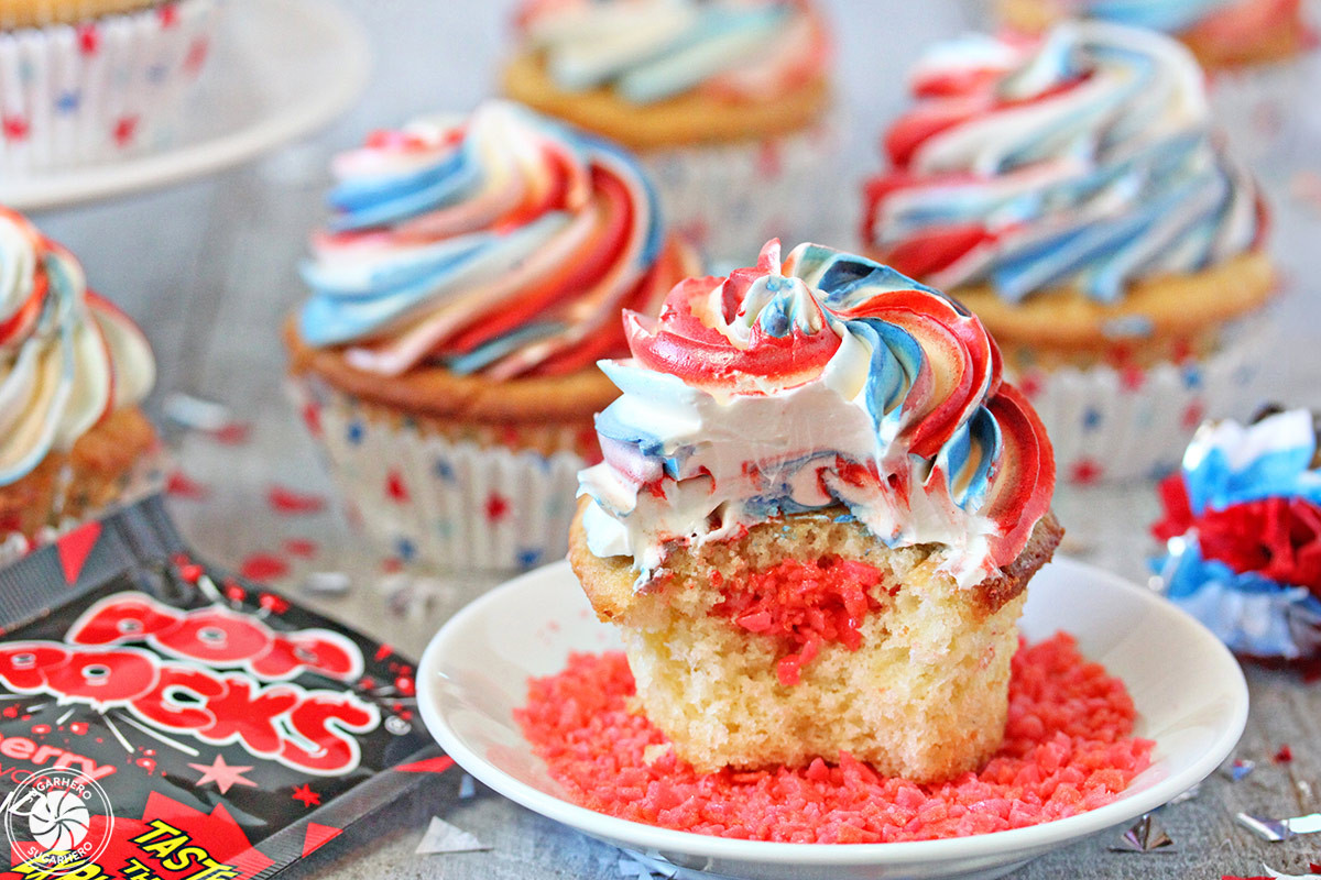 A frosted cupcake with Pop Rocks sprinkled on top, showcasing the colorful and exciting addition to the dessert.