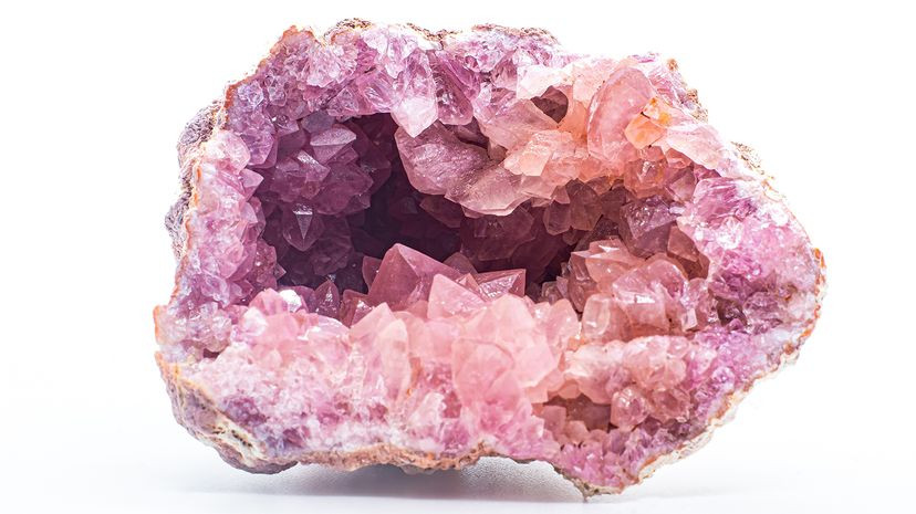 Geode exterior with a rough, bumpy texture, embedded in sedimentary rock, showcasing potential geode identification clues.