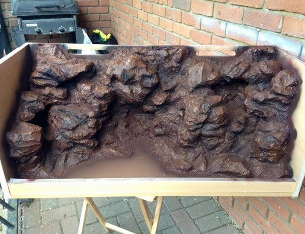 Using multiple paint colors to add depth and dimension to a fake rock wall