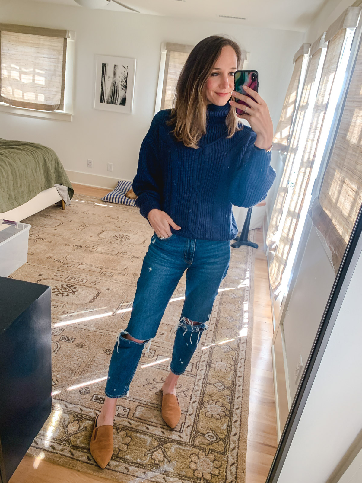 Woman wearing an oversized blue sweater with matching trousers and brown flats, creating a monochromatic look