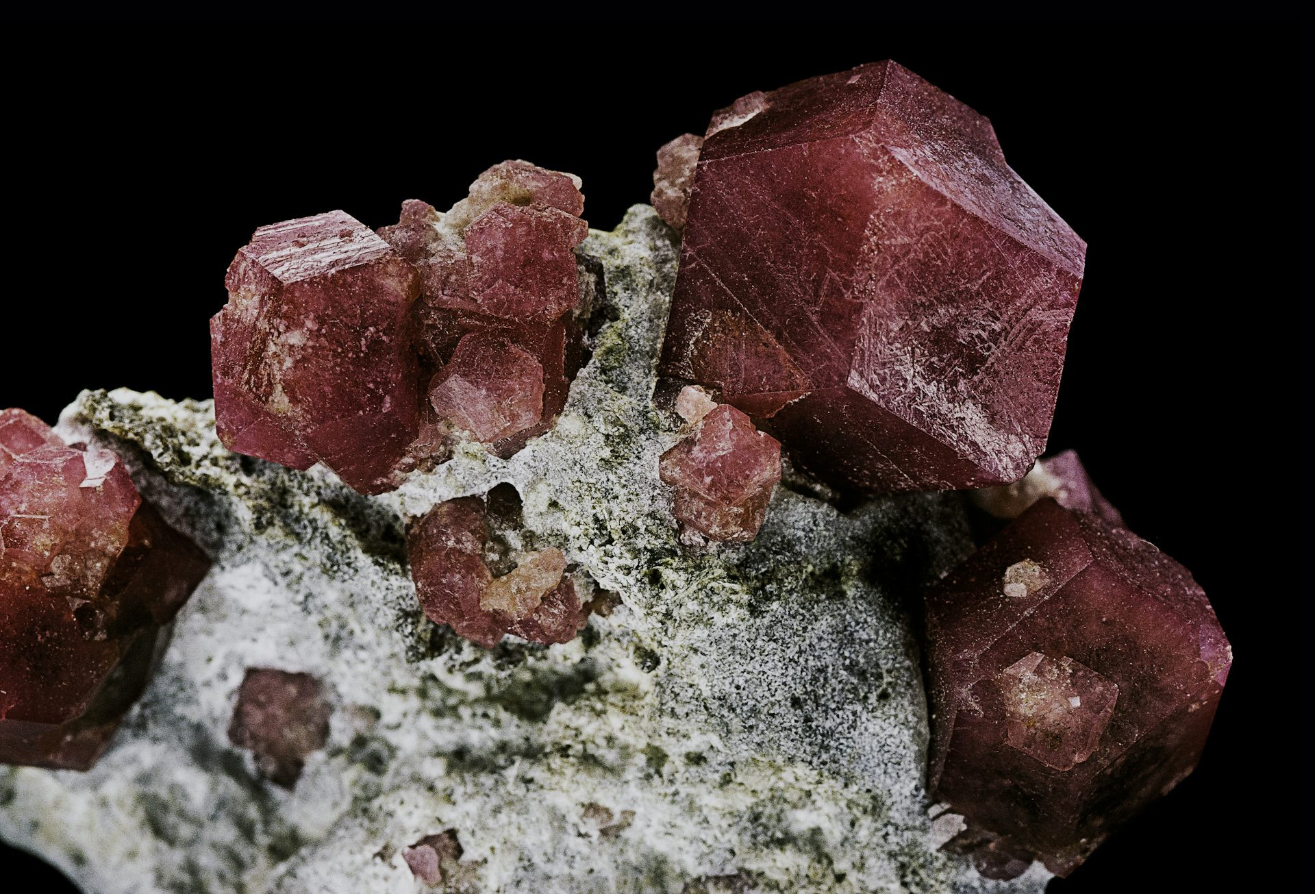 Red mineral cubes embedded in a pale grey rock