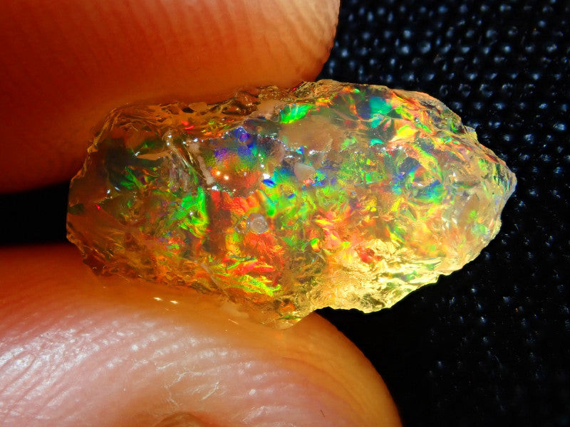 Fire Opal gemstone, showcasing its vibrant colors and mineraloid structure as a hydrated form of silica.