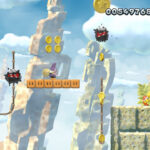 Yoshi jumping on a Fuzzy to collect the first Star Coin in Fuzzy Clifftop stage