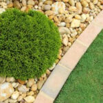 Close-up of various sizes and colors of gravel, showcasing the different options available for landscaping projects.