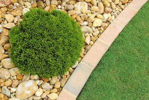 Close-up of various sizes and colors of gravel, showcasing the different options available for landscaping projects.