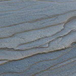 Sandstone rock surface showcasing sedimentary layers and grains