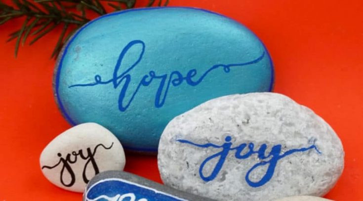 Example of hand-lettering on painted rocks, showcasing various fonts and styles