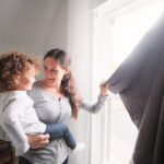 Mother and Baby Near Curtains
