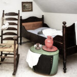 history of rocking chairs - old rocking chair with bed, trunk and old pottery