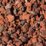 Red lava rock adds a vibrant touch to landscaping