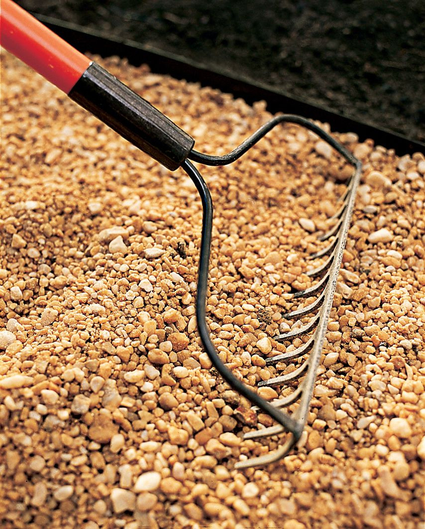 Raking the gravel into the path