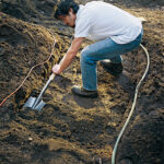 Preparing the ground for crushed rock with a shovel