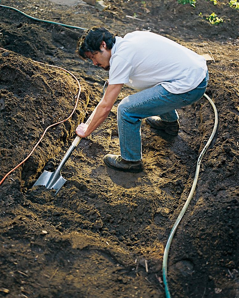 Preparing the ground for crushed rock with a shovel