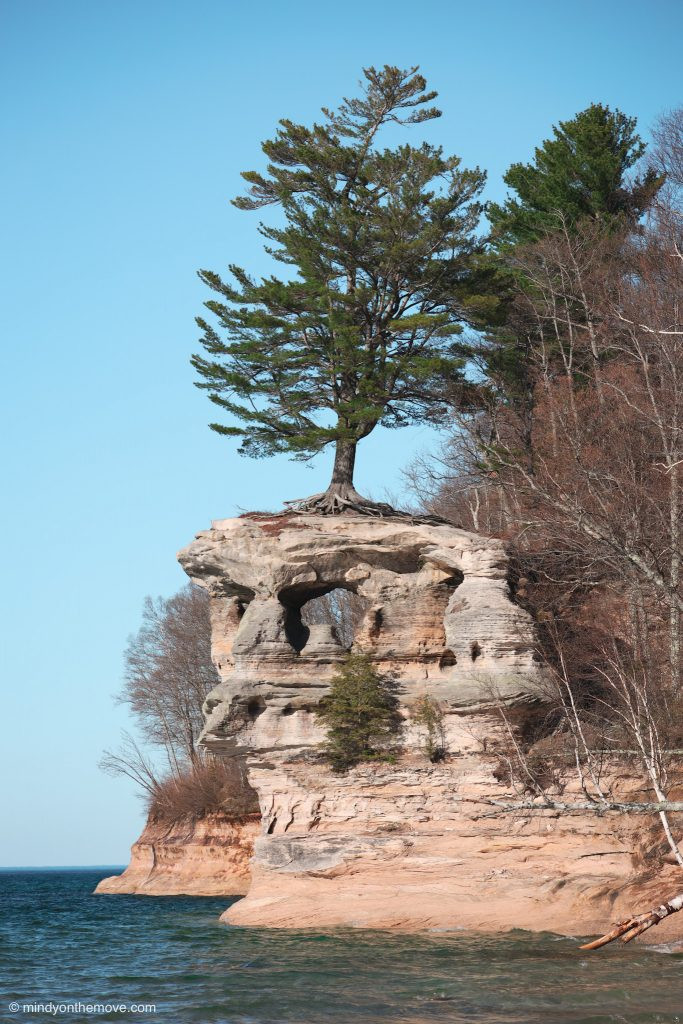 Chapel Rock surrounded by lush greenery and Lake Superior