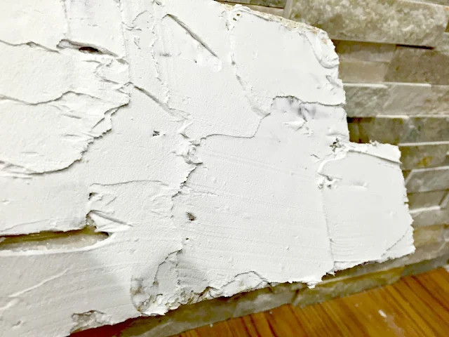 Applying adhesive to rock tile