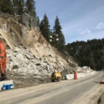 Landslide next to highway with survey crew
