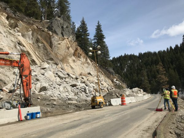 Landslide next to highway with survey crew