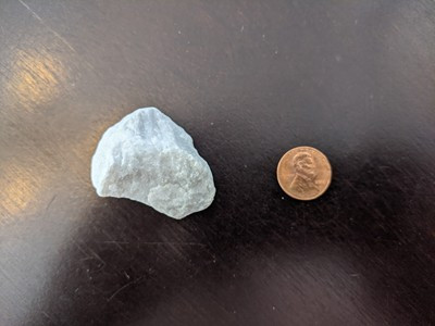 Landscaping rock compared to a penny, emphasizing its size relative to the coin