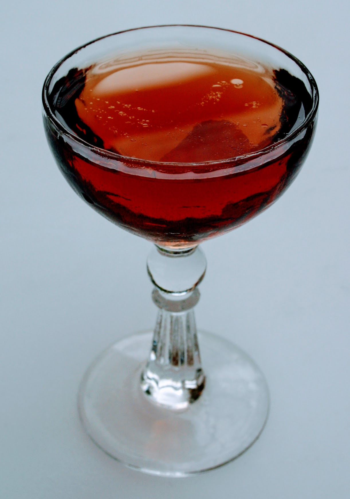 Martini served up in a stemmed glass, garnished with an olive