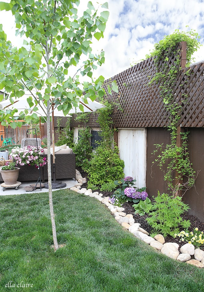 A beautifully installed river rock border framing a lush garden