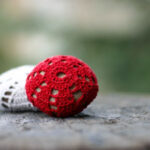 Close-up of a crocheted rock displaying intricate stitch work