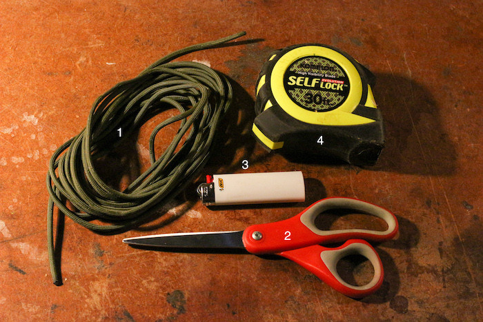 Paracord,measurement tape,scissor and a lighter for rock throwing sling.