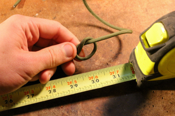 Tie a simple overhand knot about 30 inches from one end of your paracord.
