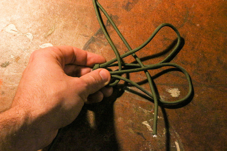 Take the long end and pass it back through the loops, alternating your weave over and under each piece of paracord as you go. Once you.