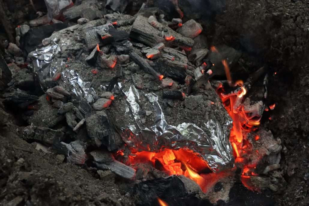 Lamb Cooked In A Pit, With Lava Rocks Underneath For Extra Heat
