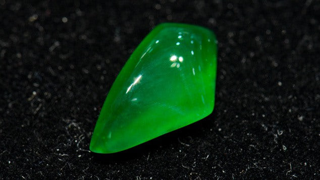 Jadeite gemstone, highlighting its dark green and translucent appearance, the most valuable form of jade.
