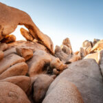 Arch Rock at Joshua Tree National Park with a clear blue sky