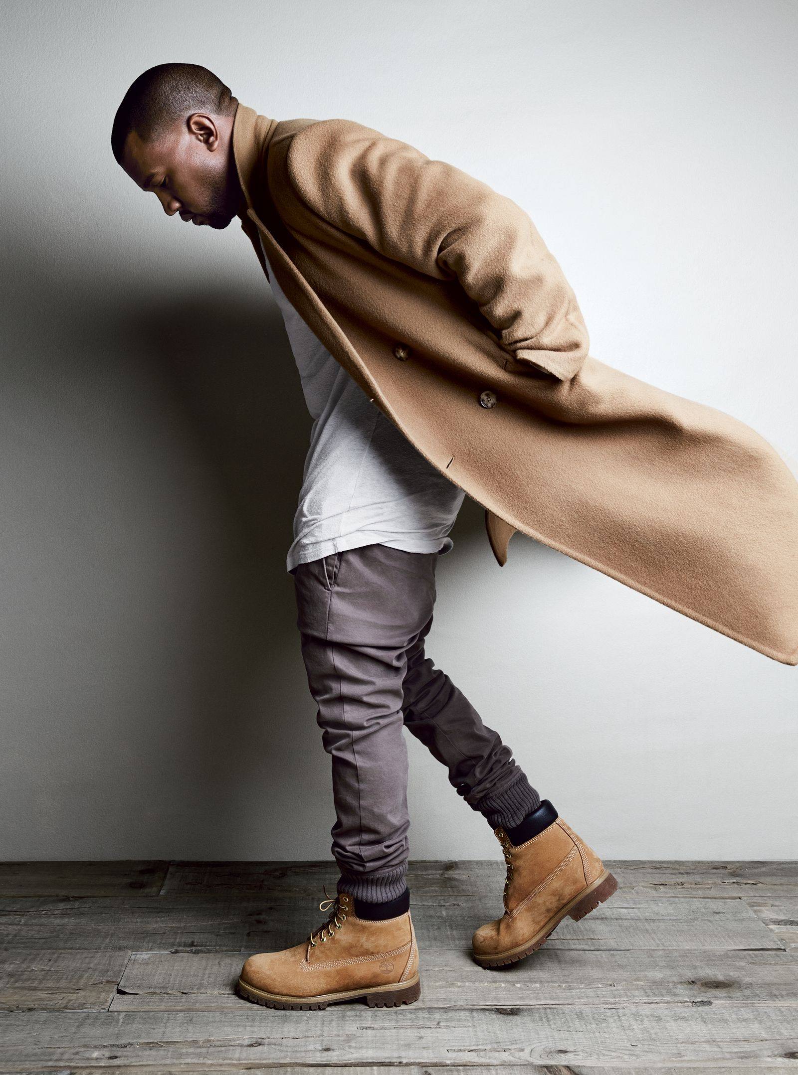 Kanye West wearing Timberland boots with a coat