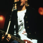 Kurt Cobain's intense performance during Nirvana's peak showcases the raw emotion and energy of their alternative rock sound