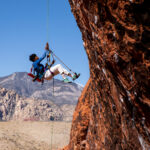 Rock climber reaching for next hold