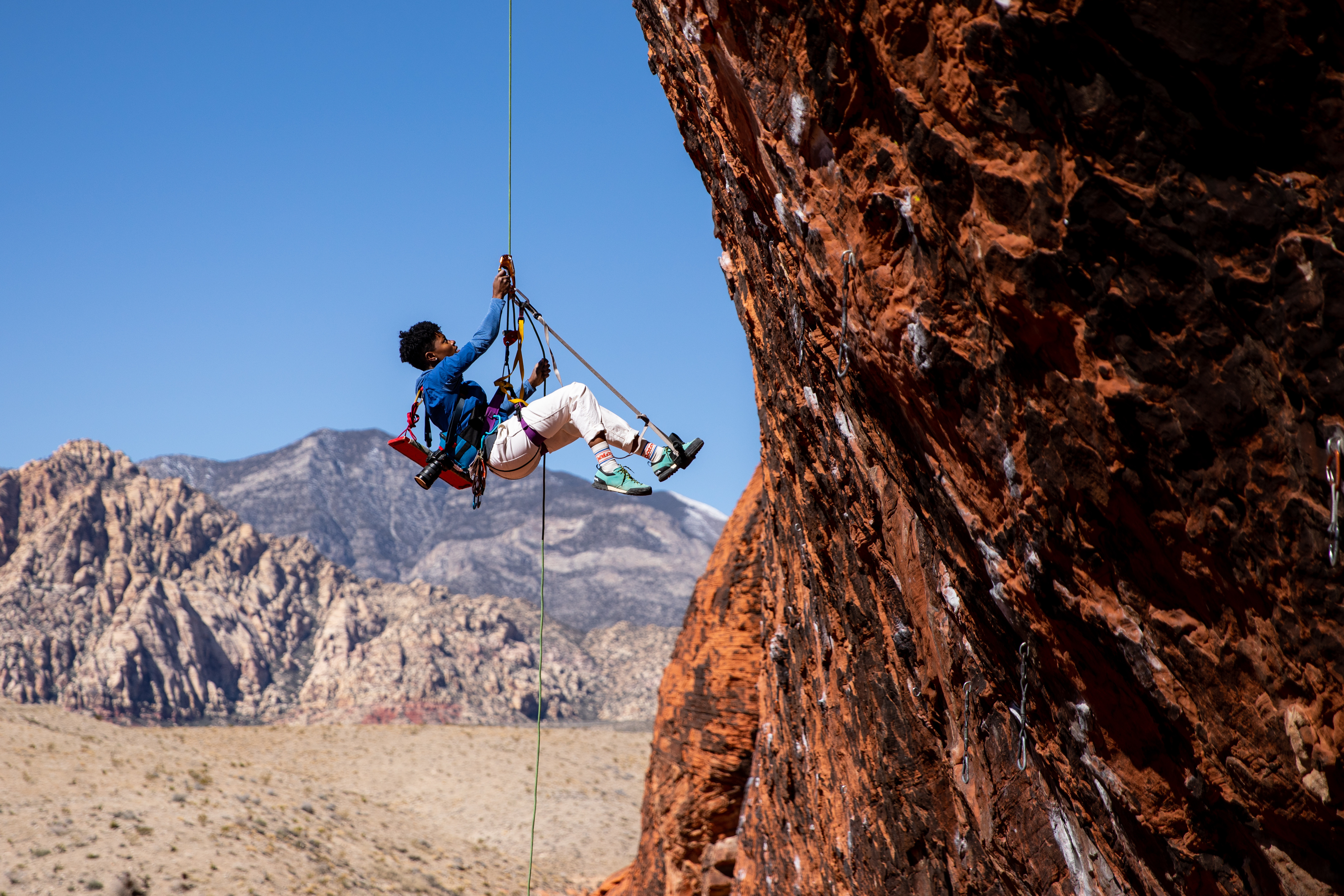 Rock climber reaching for next hold