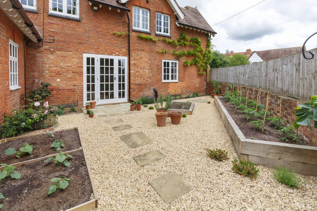 House and Garden With a Crushed Stone Terrace Patio and Stepping Stones 