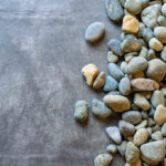 Nonwoven landscape fabric separating drain rock from the ground