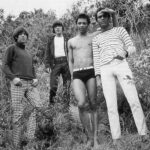 Rock of Love first season contestants posing poolside, epitomizing the show's blend of rock culture and reality TV drama
