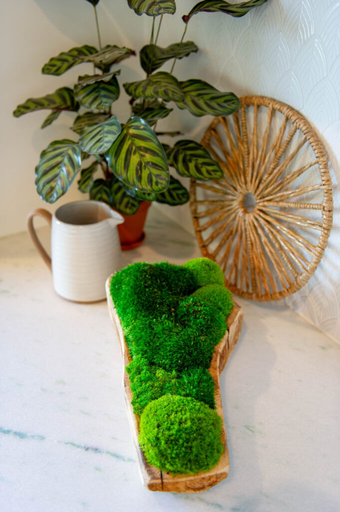 Artwork by Symbiotik Walls and plants by Living Roots Eco Living enhancing the kitchen design.